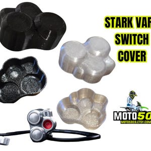 May include: Three 3D printed switch covers in the shape of a paw print. The covers are in black, silver, and gold. The text "STARK VARG SWITCH COVER" is in black text on a white background. The text "MOTO50" is in white text on a black background.