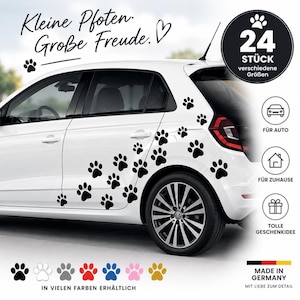 Könnte beinhalten: Ein weißes Auto mit schwarzen Pfotenabdruck-Aufklebern. Der Text lautet "Kleine Pfoten. Große Freude." und "24 STÜCK verschiedene Größen". Symbole zeigen die Verwendung für Auto, Zuhause und Geschenke. Eine Farbpalette zeigt schwarze, weiße, graue, rote, blaue, rosa und goldene Optionen.