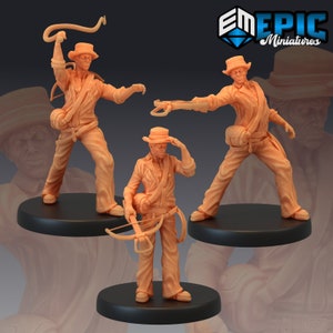 May include: Three miniature figures of adventurers, each wearing a hat and carrying a weapon. The figures are posed in action stances, with one holding a whip, another holding a crossbow, and the third holding a pistol. The figures are painted in a light brown color.