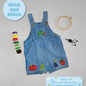May include: A blue denim overall with a green caterpillar and fruit embroidery. The embroidery includes a red apple, a green pear, a purple plum, and a red strawberry. The text "Stick and Stitch" is on a blue circle in the upper left corner of the image. The text "*Note* This is just an example. Overalls not included." is on a blue rectangle with white hearts at the bottom of the image.