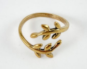 May include: A gold-toned adjustable ring with a delicate leaf design. The ring is open on one side and has a simple, minimalist style.