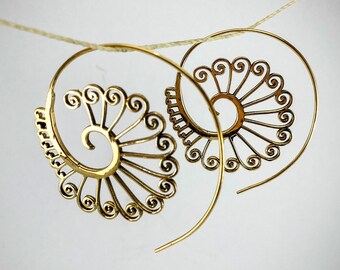 May include: A pair of gold-toned spiral hoop earrings with a delicate, intricate design. The earrings are made of metal and have a circular shape.