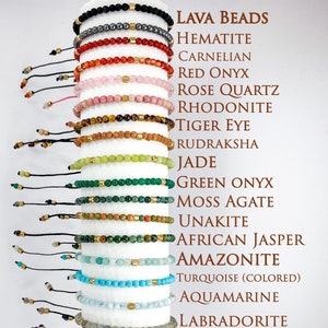 May include: A stack of 15 bracelets made with lava beads, hematite, carnelian, red onyx, rose quartz, rhodonite, tiger eye, rudraksha, jade, green onyx, moss agate, unakite, African jasper, amazonite, turquoise, aquamarine, labradorite, lapis lazuli, amethyst, and moonstone.