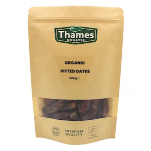 May include: A brown paper bag with a clear window showing organic pitted dates. The bag has the text "Thames Organic" and "Organic Pitted Dates 500g e" printed on it. The bag also has a logo for the Soil Association Organic and the text "Premium Quality".