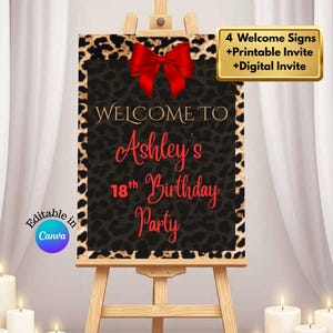 May include: A welcome sign for Ashley's 18th birthday party. The sign features a black background with a leopard print border and a red bow. The text "WELCOME TO Ashley's 18th Birthday Party" is displayed in elegant fonts. The sign is on a wooden easel.