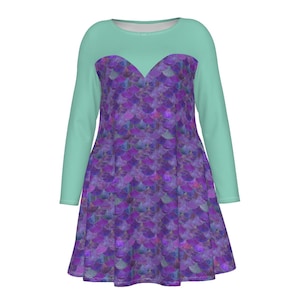 May include: A long-sleeved dress with a teal bodice and sleeves. The dress features a purple and blue scale pattern on the bodice and skirt. The dress has a round neckline and a fitted waist.