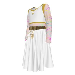 May include: A white dress with a gold-trimmed bodice and a flared skirt. The long sleeves are light pink with a rainbow pattern. A gold belt and necklace with a star pendant and a decorative charm complete the look. The dress is designed for a child.
