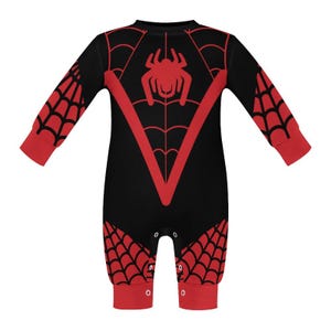 May include: Black and red long-sleeved baby onesie with a spider web design and a red spider graphic.