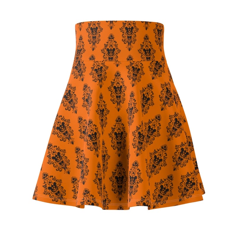 May include: An orange skater skirt with a black and white print of a haunted house with Mickey Mouse heads.