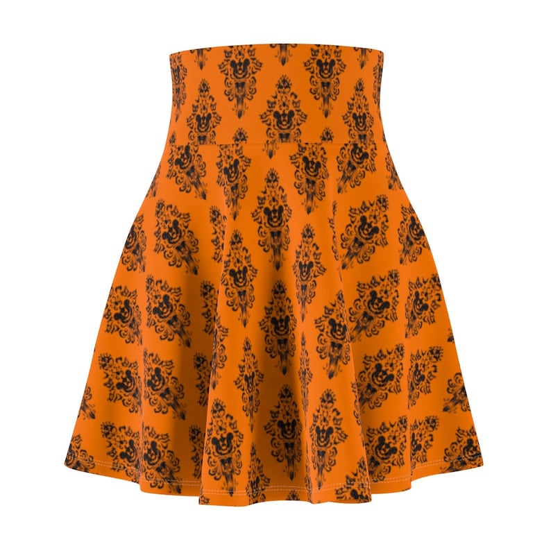 May include: Orange skater skirt with a black and white print of a haunted house with Mickey Mouse ears.
