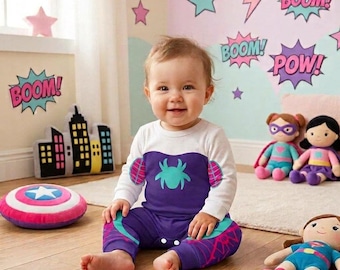 May include: A long-sleeved baby romper featuring a white top and a purple bottom section with a light blue spider graphic on the chest. The sleeves and legs have purple and light blue spiderweb patterns, and the garment includes snap closures.