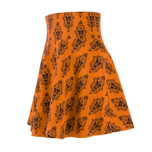 May include: Orange skirt with a black and white print of a haunted house with Mickey Mouse heads.