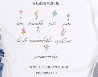 Könnte beinhalten: Weißes T-Shirt mit einem Blumendesign und dem Text "WHATEVER IS... true honorable just pure lovely commendable excellent praiseworthy THINK OF SUCH THINGS Philippians 4:8"