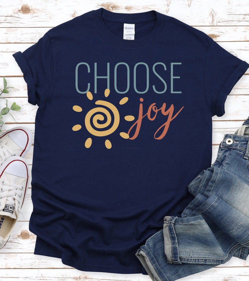 May include: A navy blue t-shirt with a yellow sun and the text "CHOOSE joy" in teal and red.