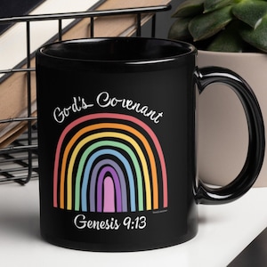 May include: Black coffee mug featuring a rainbow and the text "God's Covenant" and "Genesis 9:13".