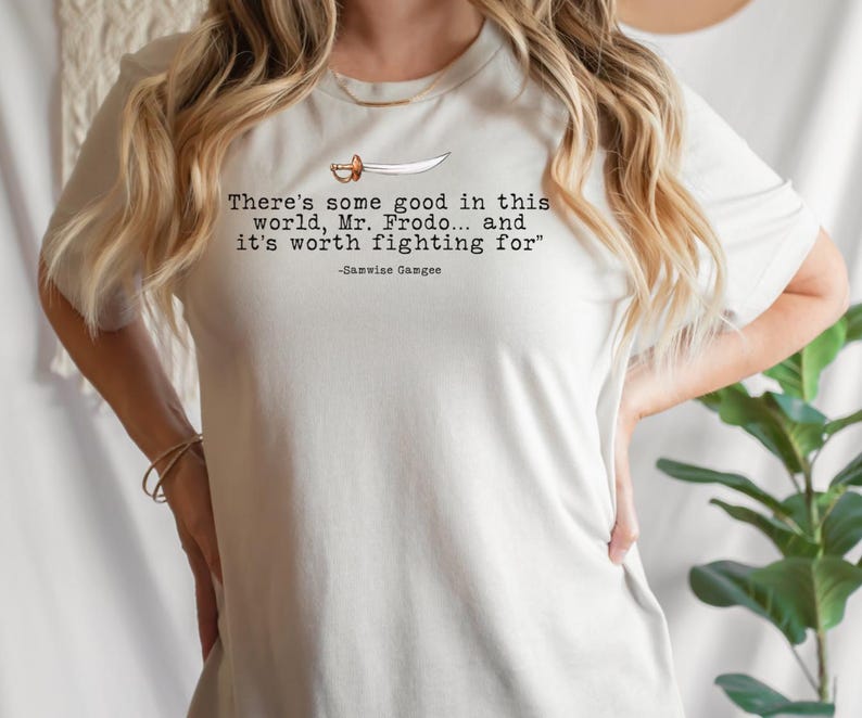 May include: White t-shirt with a quote from the Lord of the Rings: "There's some good in this world, Mr. Frodo... and it's worth fighting for" -Samwise Gamgee.