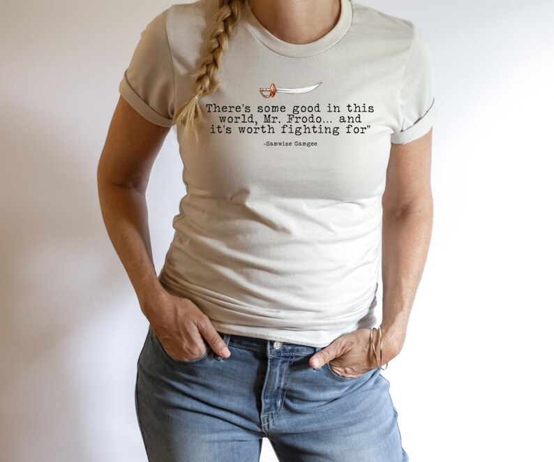 May include: A light beige t-shirt with a quote from the Lord of the Rings: "There's some good in this world, Mr. Frodo... and it's worth fighting for" -Samwise Gamgee.