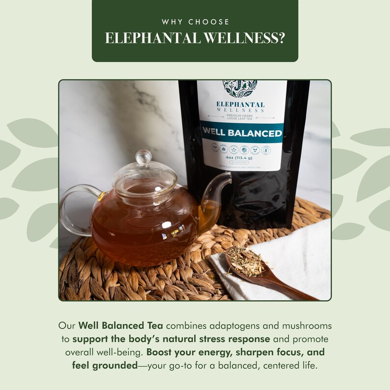 May include: A black bag of "Well Balanced" herbal tea from Elephantal Wellness. The bag is sitting on a woven surface next to a glass teapot filled with brown tea. The tea bag features a green logo with a stylized elephant and the text "Elephantal Wellness".