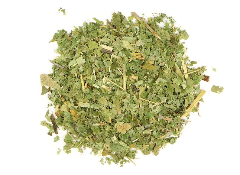 May include: A close-up of a pile of dried green and brown herbs, likely for tea or herbal remedies.