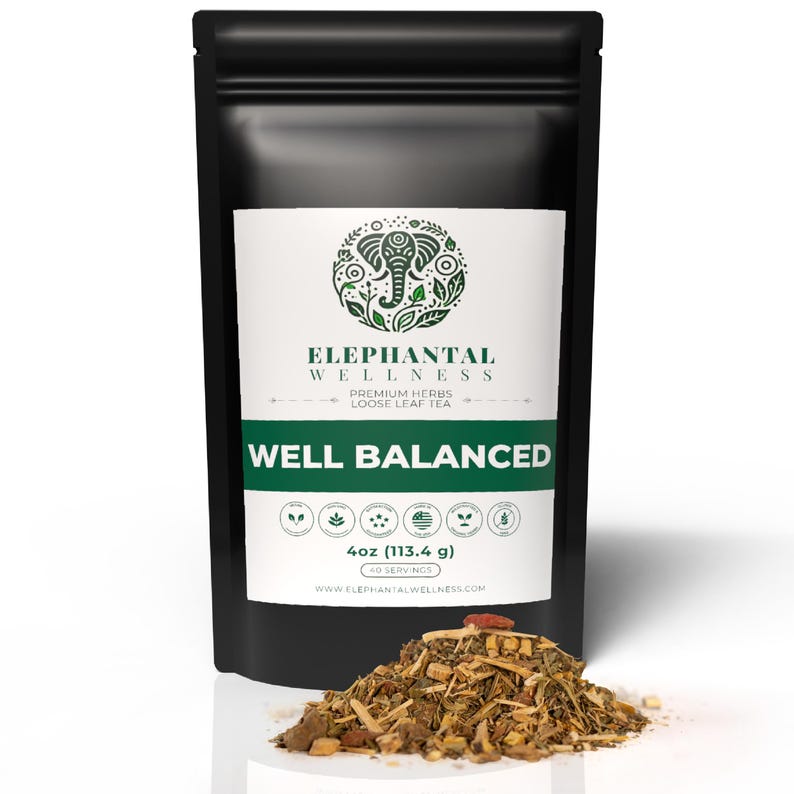 May include: A black pouch with a white label that reads "ELEPHANTAL WELLNESS" and "WELL BALANCED". The pouch contains 4 ounces (113.4 grams) of loose leaf tea. The tea is a blend of herbs and spices.