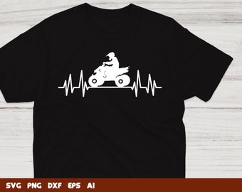 May include: A black t-shirt featuring a white silhouette of a person riding an ATV with a heartbeat graphic behind it.