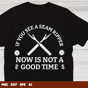 May include: Black t-shirt with a white graphic design. The graphic features a pair of crossed seam rippers with the text "If you see a seam ripper now is not a good time".