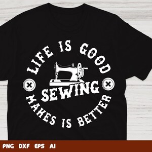 May include: Black t-shirt with a white circle design featuring a sewing machine and the text "Life is good sewing makes is better".