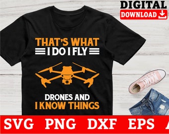 May include: Black t-shirt with orange text that reads "That's what I do I fly= Drones and I know things". A drone is pictured in the center of the shirt.