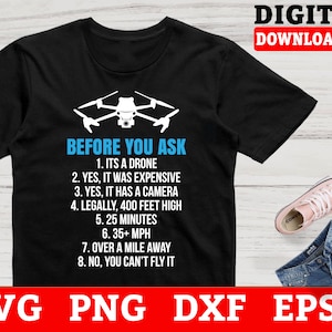 May include: A black t-shirt with a white drone graphic and the text "Before You Ask" with a list of facts about drones. The text includes: "It's a drone", "It was expensive", "It has a camera", "Legally, 400 feet high", "25 minutes", "35+ MPH", "Over a mile away", and "You can't fly it".