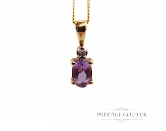May include: A gold chain necklace with a pendant featuring a purple oval gemstone and a small diamond accent.