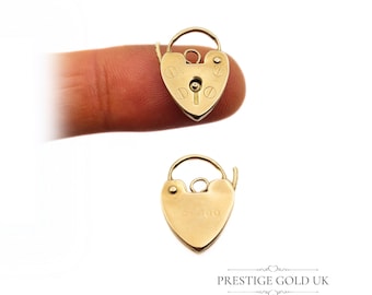 May include: A gold heart-shaped padlock charm with a working keyhole and a small loop at the top. The charm is about the size of a fingernail.