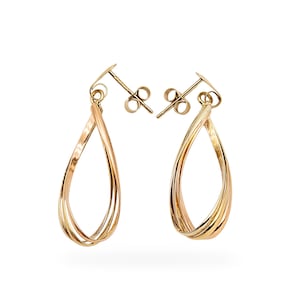 May include: A pair of gold teardrop earrings with a twisted design. The earrings feature a combination of yellow, rose, and white gold, creating a tri-color effect. The earrings have post backs for secure wear.