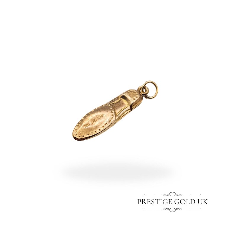 Side view of the lightweight hollow 9ct gold moccasin charm with detailed stitching and smooth polished finish, measuring 24mm in length.
