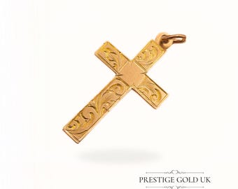 May include: A gold cross pendant with an intricate floral design. The cross is made of solid gold and has a polished finish.