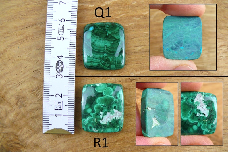 May include: Two malachite gemstones, labeled Q1 and R1, are displayed. The gemstones are rectangular with rounded corners. The malachite features a vibrant green color with swirling patterns. A ruler is placed next to the gemstones, showing measurements in centimeters.