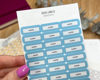 Pode incluir: Uma folha de etiquetas personalizadas para o painel, de cor azul e branca, com o texto "DASH LABELS HORIZON BLUE" e "STICKER PAGE" impresso na folha.