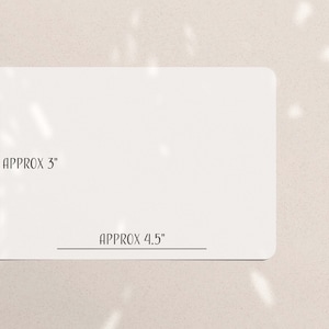 May include: A white rectangular card with rounded corners. The card's dimensions are approximately 3 inches by 4.5 inches. The text "APPROX 3" and "APPROX 4.5" are printed on the card.