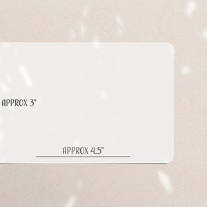 May include: A white rectangular card with rounded corners. The card's dimensions are approximately 3 inches by 4.5 inches. The text "APPROX 3" and "APPROX 4.5" are printed on the card.