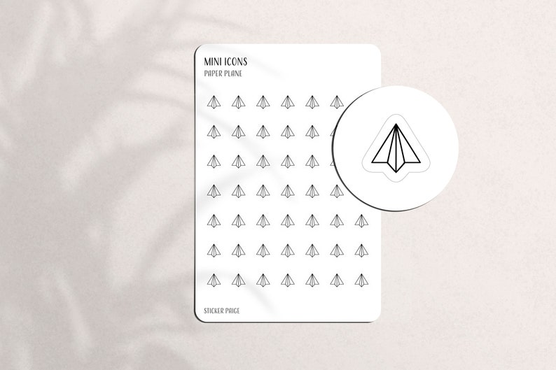 May include: White sticker sheet with black paper airplane icons. The sheet includes the text "MINI ICONS PAPER PLANE" and "STICKER PAGE". A circular sticker with a paper airplane design is also shown.