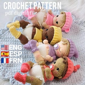 May include: Four handmade crochet dolls wearing hats, shirts, and diapers. The dolls feature various skin tones and yarn colors including pink, yellow, purple, and coral. Each doll has black eyes and some have pacifiers. Text reads CROCHET PATTERN pdf digital file.