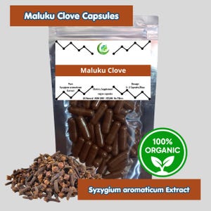May include: A clear resealable pouch filled with brown capsules labeled Maluku Clove. The label includes text stating Pure Syzygium aromaticum Extract, Dietary Supplement, and vegan capsules. A pile of dried whole cloves sits beside the pouch.