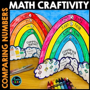 May include: Colorful rainbow-shaped educational craft titled "Comparing Numbers." The craft features numbers, comparison symbols, and the words "Greater Than," "Less Than," and "Equal To." Crayons and scissors are also visible.
