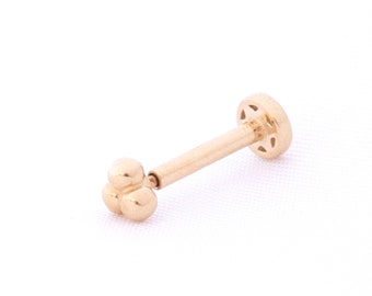 May include: Gold body jewelry with a small flower-shaped end and a flat back.