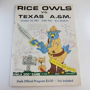 May include: A vintage Rice Owls vs. Texas A&M. football game program from October 22, 1983. The program features a cartoon mascot of the Rice Owls, a blue owl wearing a ranger uniform, holding a rifle and a sign that says "For Points Not Made!" The program also features a smaller cartoon dog mascot with a sign that says "No Dogs Allowed!" The program is signed by several players, including Ken Reince #57.