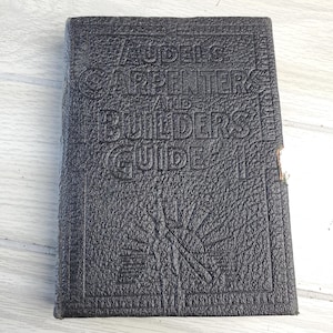 May include: A black leather-bound book with the title "The Judges Carpenter and Builders Guide".