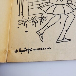 Op de afbeelding: Zwart-witte kleurplaat met een meisje in een rok en schoenen, dat langs een bakstenen muur en bloemen rent. De pagina bevat de copyrighttekst "Imprint/Art Fair Lawn, N.J. 1974".