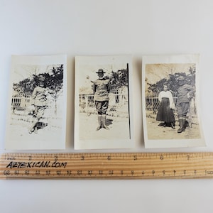 May include: Three black and white photographs of people in military uniforms. The first photo shows a person in a military uniform standing in front of a fence. The second photo shows a person in a military uniform standing in front of a building. The third photo shows two people in military uniforms standing in front of a fence.