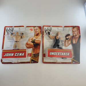 Vintage WWE Action Figure Lot with John Cena and The Undertaker Unopened on Card Backs