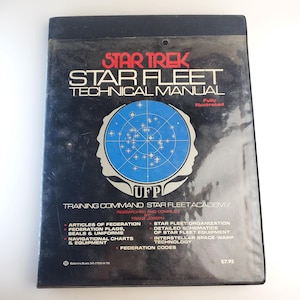 May include: A black and silver Star Trek Star Fleet Technical Manual book cover with a blue and white UFP logo and the text "Star Trek Star Fleet Technical Manual" and "Training Command Star Fleet Academy".