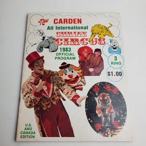 May include: A vintage 1983 program for the New Carden All International Shrine Circus. The cover features a clown in a red and white costume, a tiger, and the text "3 Ring $1.00".